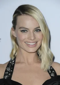 Margot Robbie applies cream for breastfeeding moms to her lips