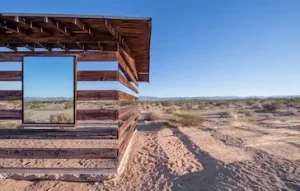 A wooden shelter with mirrors in the California desert